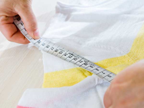 Supplier measuring shirt to check specifications